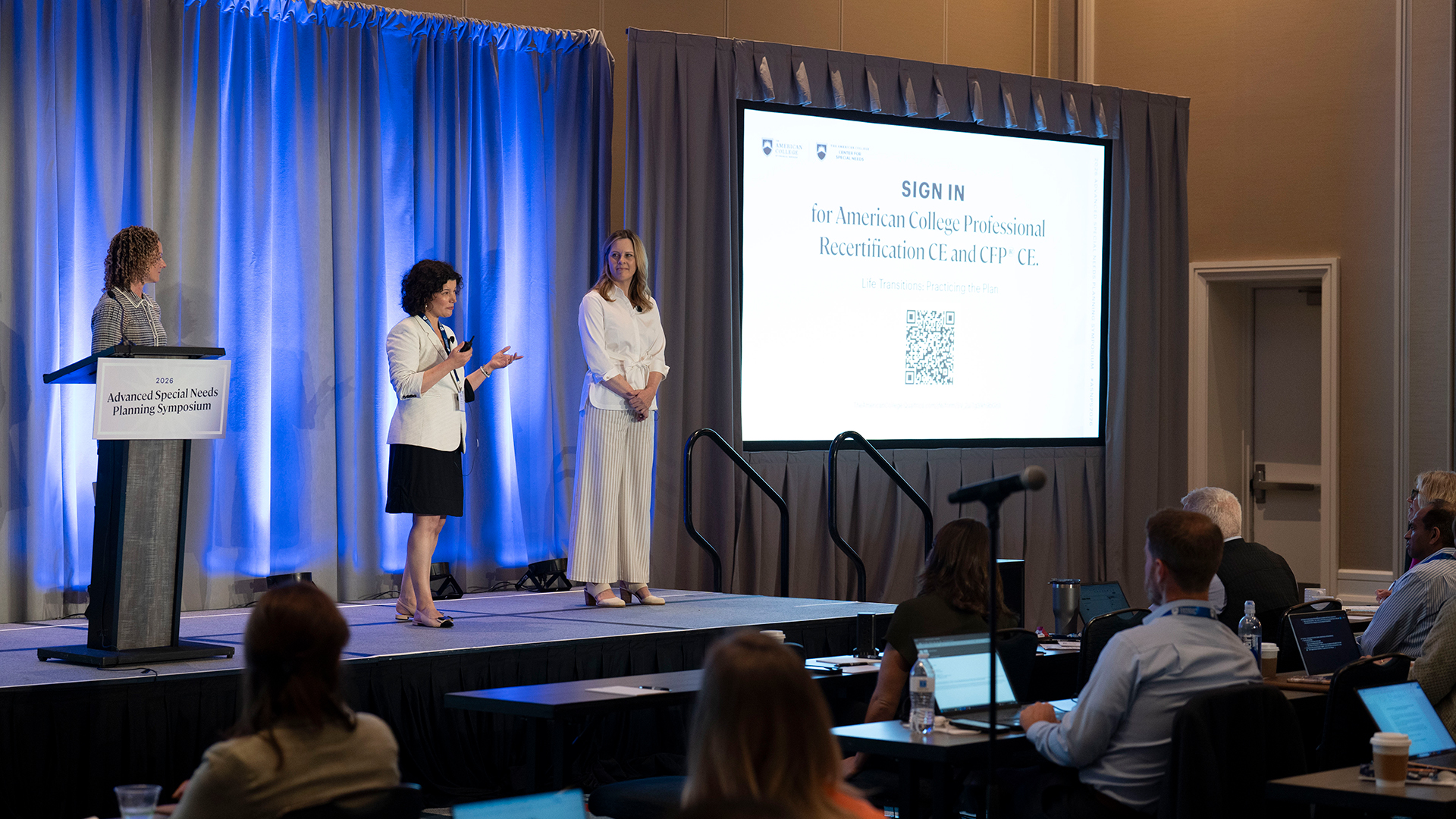 Speakers on stage at a conference