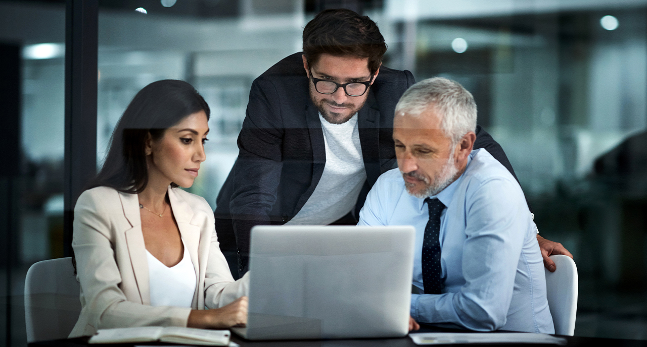 Group of coworkers gathered around the computer