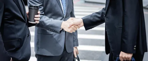Financial professionals shaking hands