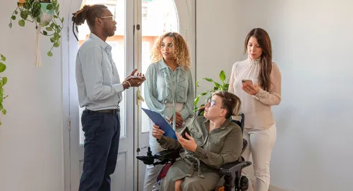 A male advisor speaking to a family caring for a special needs individual