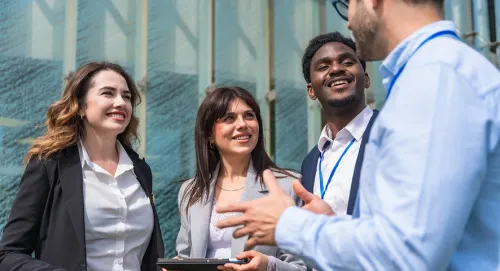 Group of four colleagues talking together