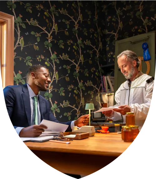 Beekeeper and his financial advisor talking at the table