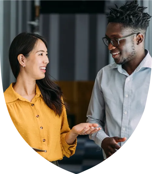 Middle aged male and female professionals smiling and talking together