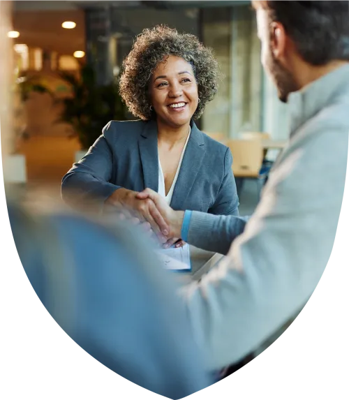Middle aged woman smiling and shaking hands
