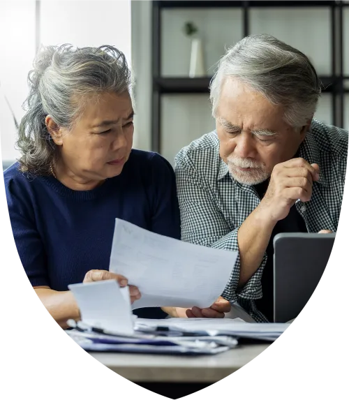 An elderly couple sitting down planning for retirement together