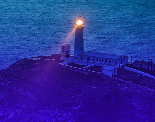 Lighthouse shining a light in the dark