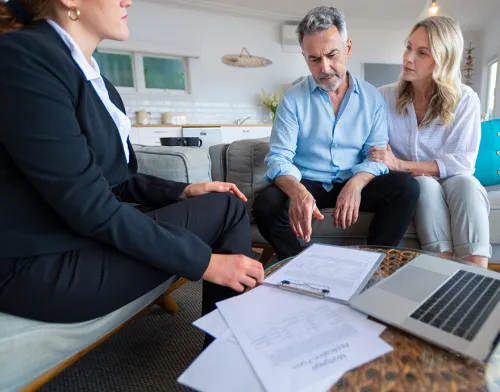 Woman looking at paperwork with her clients