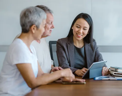 Female financial advisor working with elderly couple