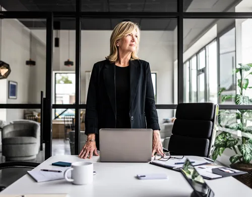 Woman standing confidently in the board room