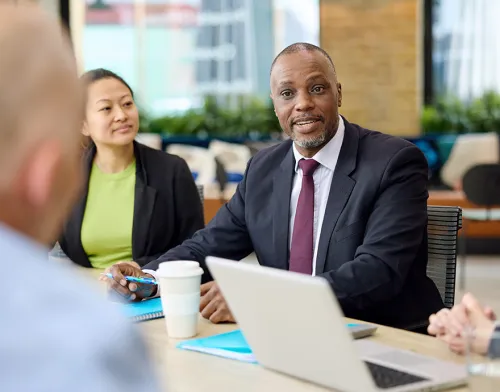 Middle aged man smiling at the conference table