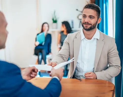 Young professional male receiving a piece of paper