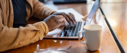 Man typing on his laptop