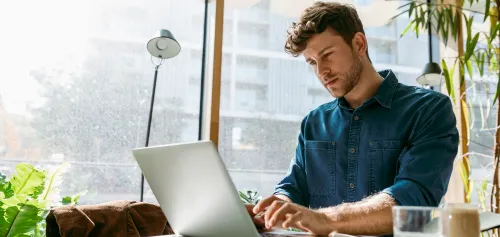 Man in his early 40's working at his desk