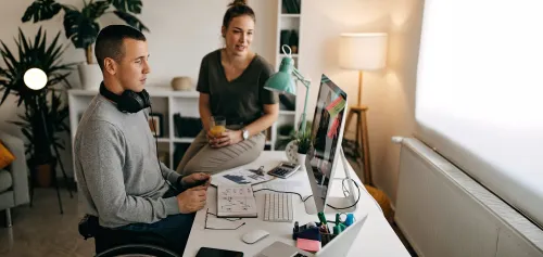 Man with special needs sitting at his desk working