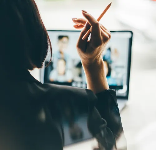 Woman sitting at her desk on a virtual meeting