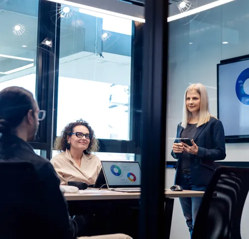 Two women and a man having a meeting in a conference room