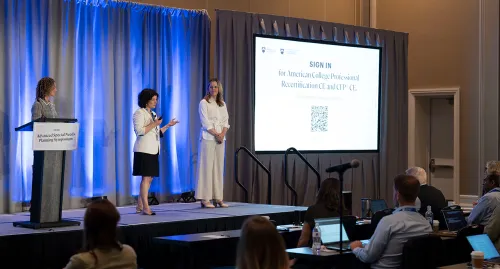 Speakers on stage at a conference