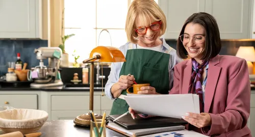 Elderly woman in her kitchen speaking with her financial advisor
