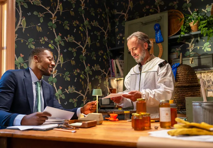 Beekeeper and his financial advisor talking at the table